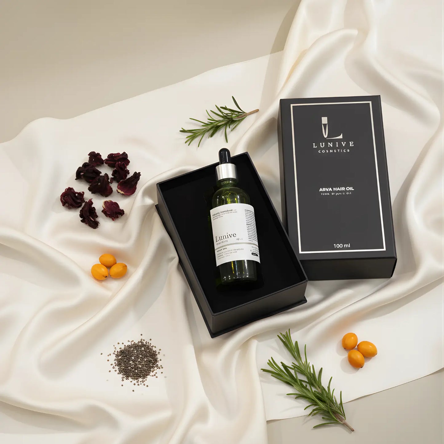 Lunive hair oil bottle with packaging on a white fabric background