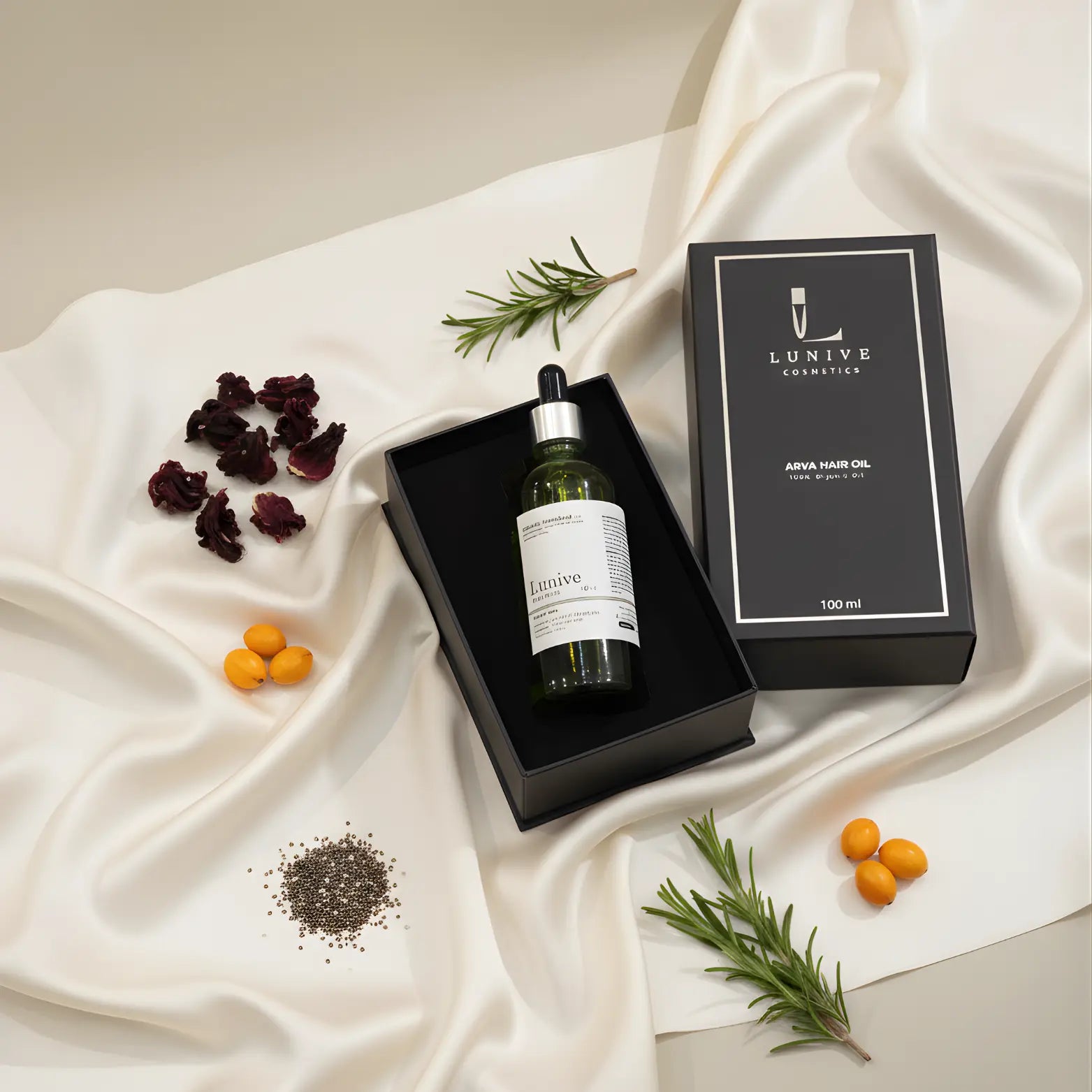 Lunive hair oil bottle with packaging on a white fabric background